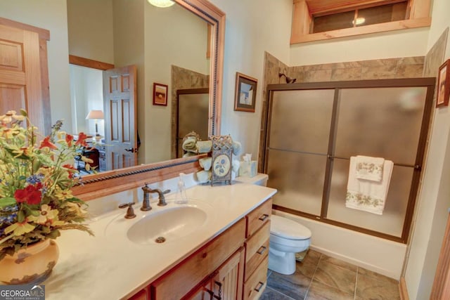 full bathroom featuring toilet, shower / bath combination with glass door, vanity, and tile patterned floors