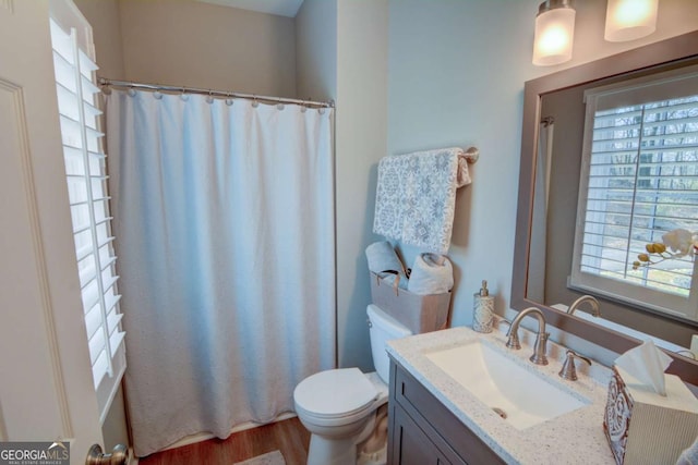 full bath with toilet, curtained shower, wood finished floors, and vanity