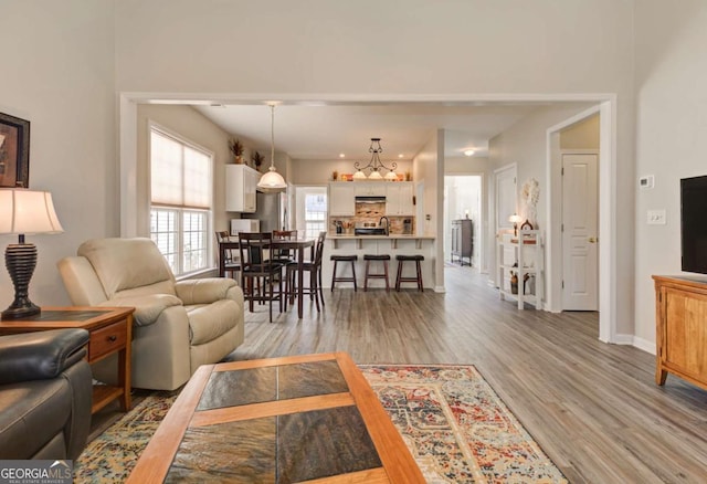 living area with light wood finished floors and baseboards