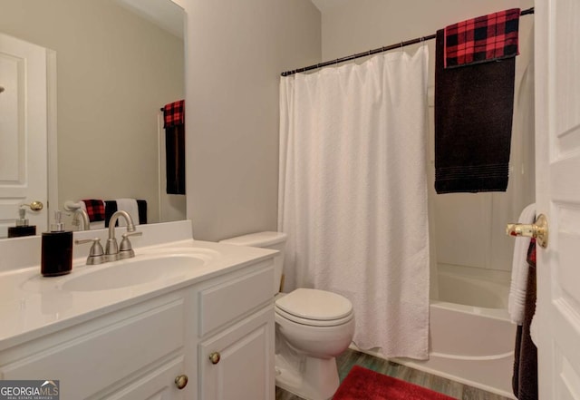 bathroom featuring vanity, toilet, and shower / bath combo with shower curtain