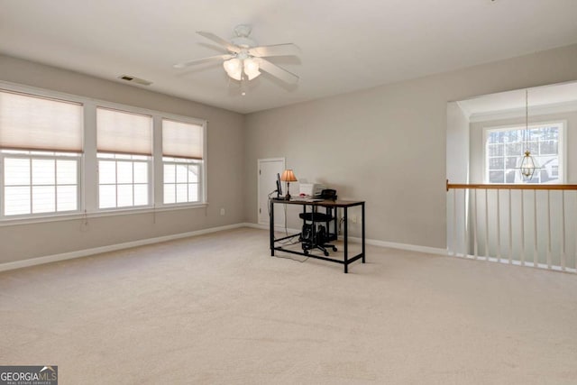 carpeted home office featuring visible vents, baseboards, and ceiling fan