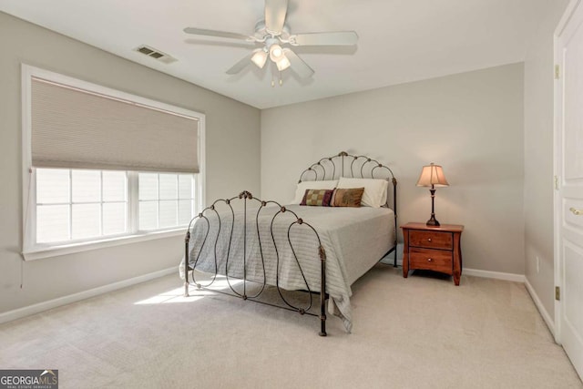 bedroom featuring visible vents, ceiling fan, light carpet, and baseboards