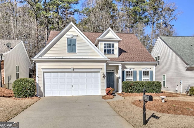 view of front of home featuring a garage, driveway, and roof with shingles