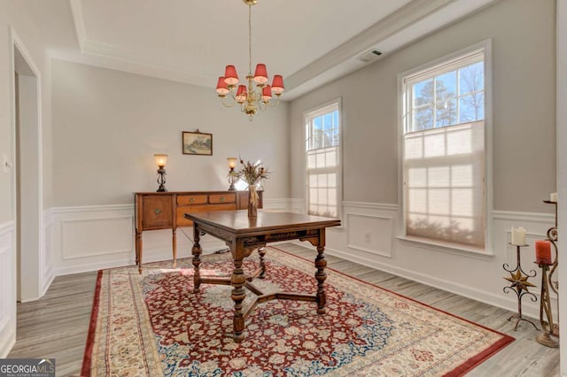 office area with a notable chandelier, visible vents, wood finished floors, and wainscoting