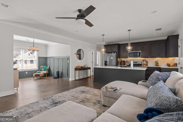 living room with ornamental molding, dark wood finished floors, a ceiling fan, and recessed lighting