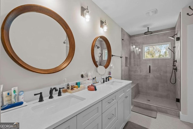 full bath featuring a stall shower, tile patterned floors, a sink, and double vanity