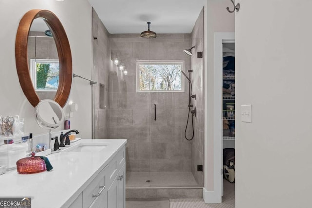 bathroom featuring a shower stall, tile patterned flooring, and vanity