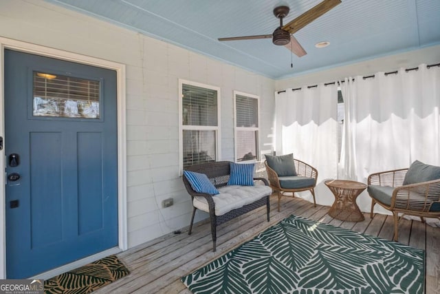 exterior space featuring concrete block siding and a ceiling fan