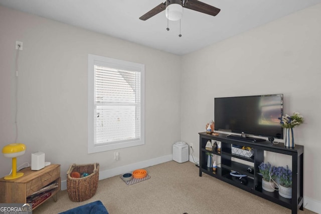 interior space featuring carpet floors, baseboards, and a ceiling fan