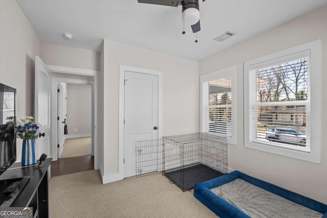 bedroom with carpet floors, visible vents, ceiling fan, and baseboards