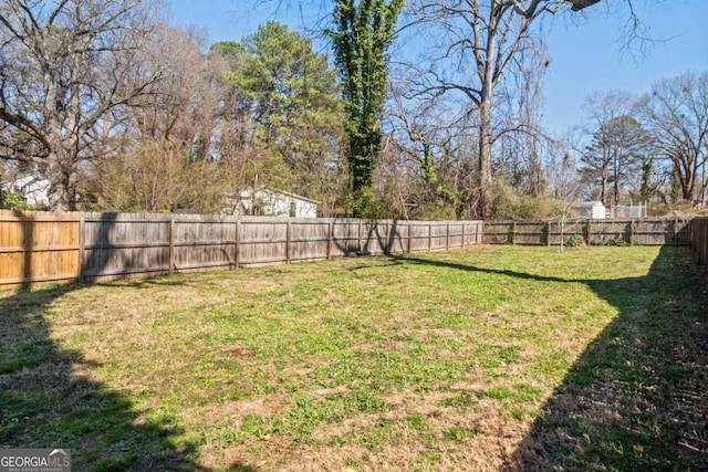 view of yard with a fenced backyard