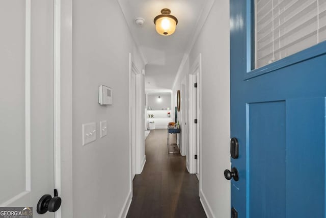 hallway featuring dark wood finished floors and baseboards