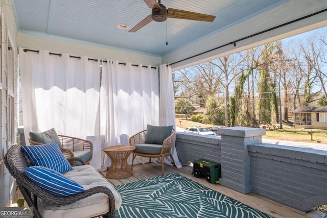 sunroom featuring ceiling fan