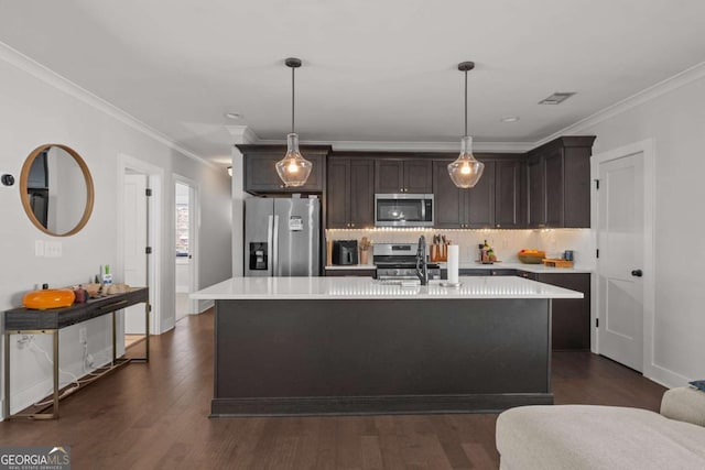 kitchen with stainless steel appliances, tasteful backsplash, light countertops, and dark brown cabinetry