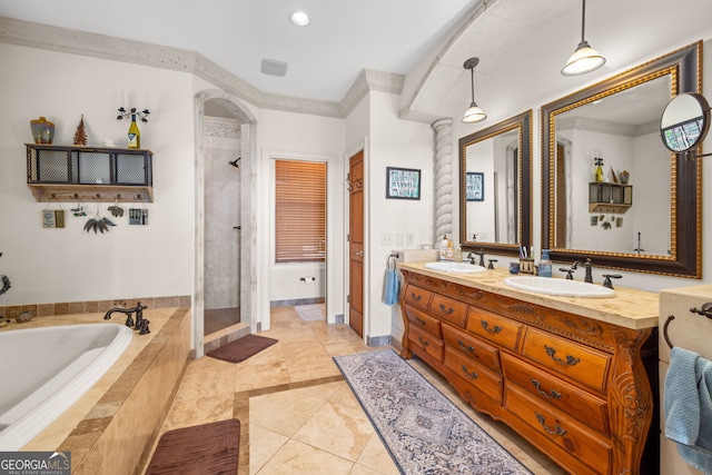 full bathroom featuring a stall shower, a garden tub, and a sink