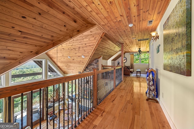 corridor featuring wood ceiling, visible vents, vaulted ceiling, and hardwood / wood-style flooring