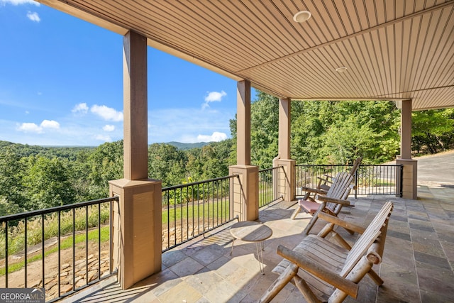 view of patio / terrace with a forest view