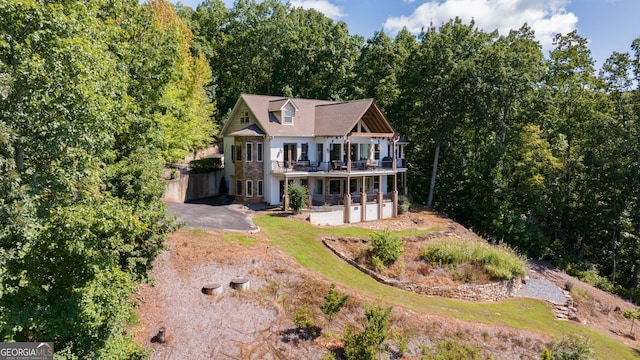 view of front of house with driveway and a deck