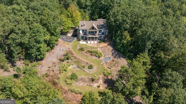 birds eye view of property with a forest view