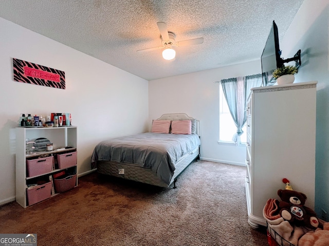 carpeted bedroom with a textured ceiling, baseboards, and a ceiling fan