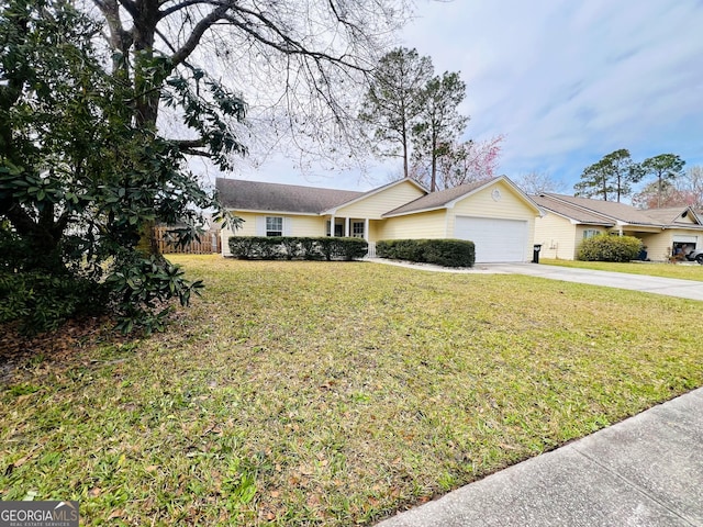 ranch-style home with a front yard, driveway, and an attached garage