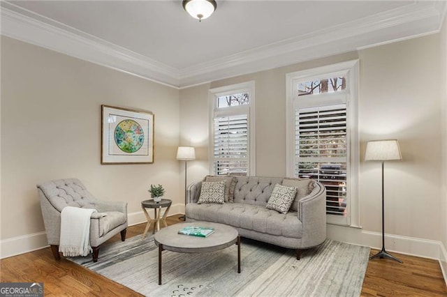 living room with ornamental molding, wood finished floors, and baseboards