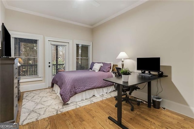 bedroom with wood finished floors, a ceiling fan, access to exterior, baseboards, and ornamental molding