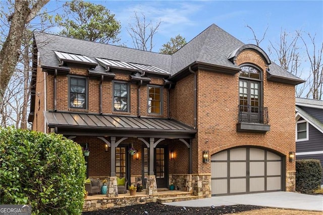 view of front of home with stone siding, a standing seam roof, covered porch, and metal roof