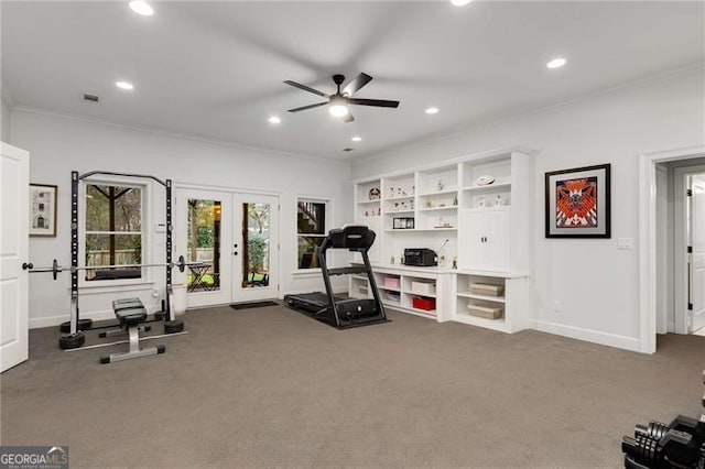 exercise area featuring baseboards, french doors, carpet, and crown molding