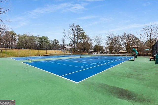 view of sport court with fence