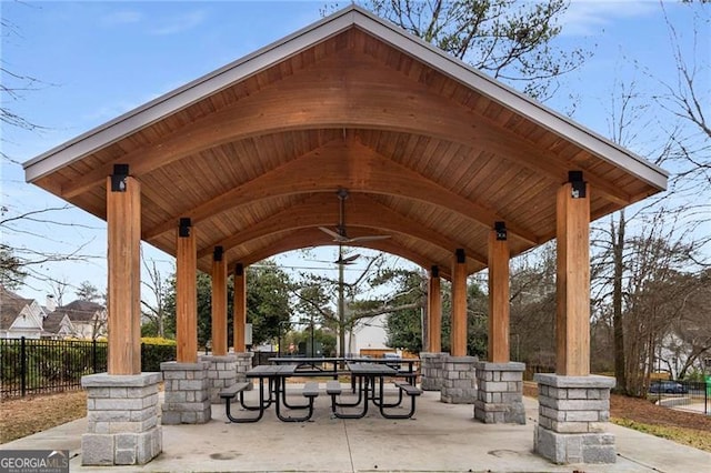 view of property's community with fence and a gazebo