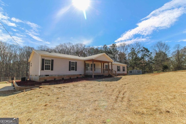 view of front of home featuring crawl space, a front lawn, and a porch