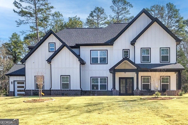 modern inspired farmhouse with french doors, board and batten siding, a shingled roof, and a front lawn