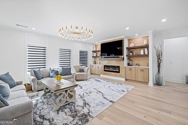 living room with recessed lighting, visible vents, light wood finished floors, a glass covered fireplace, and crown molding