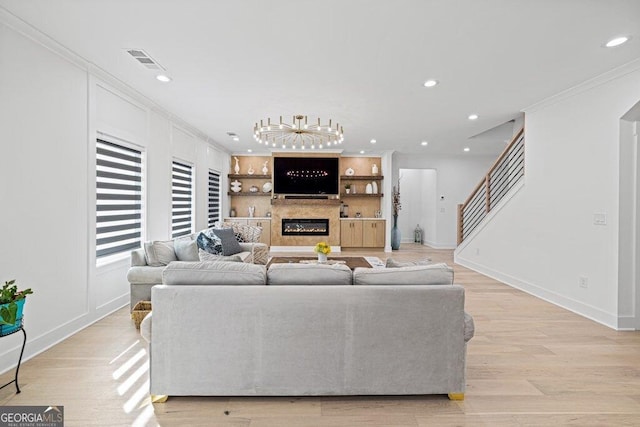 living area with recessed lighting, visible vents, and crown molding