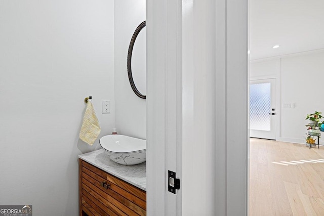 bathroom featuring wood finished floors and vanity