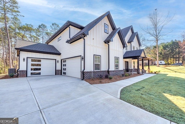 view of home's exterior featuring a yard, cooling unit, board and batten siding, and concrete driveway