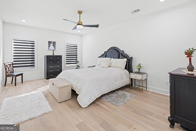 bedroom featuring light wood-style flooring, visible vents, and baseboards