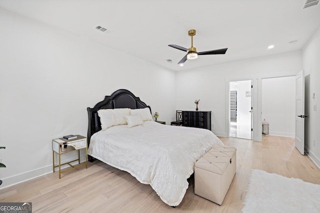 bedroom featuring light wood-style flooring, visible vents, and baseboards