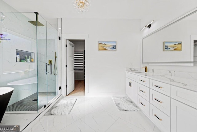 full bath featuring marble finish floor, a soaking tub, vanity, and a marble finish shower