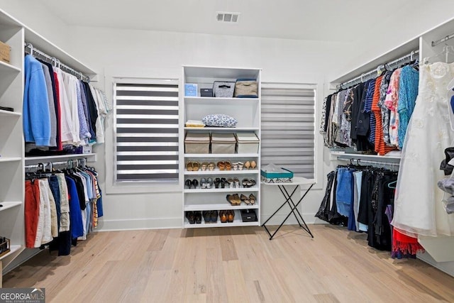 spacious closet featuring visible vents and wood finished floors