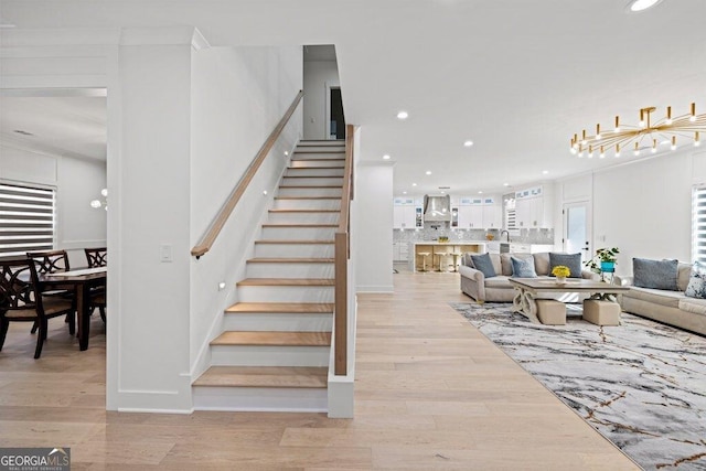 stairs with recessed lighting and wood finished floors