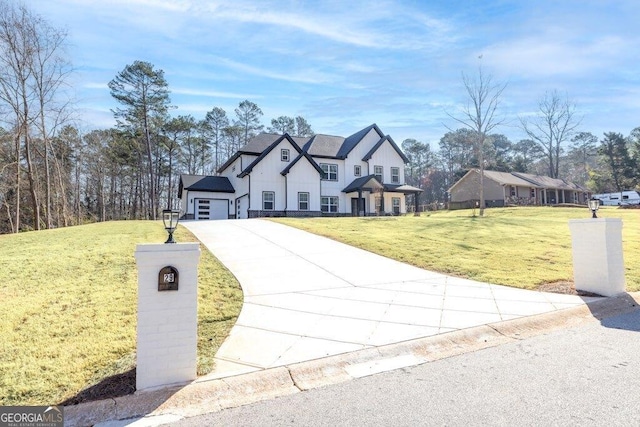 view of front of house featuring a garage, driveway, and a front lawn