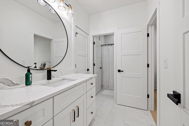 full bath featuring marble finish floor, a shower with curtain, and vanity