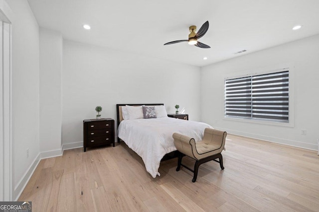 bedroom with baseboards, visible vents, wood finished floors, and recessed lighting