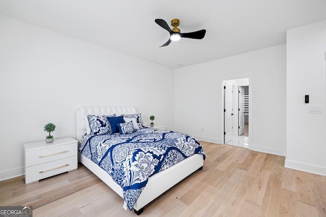 bedroom with baseboards, ceiling fan, and light wood finished floors