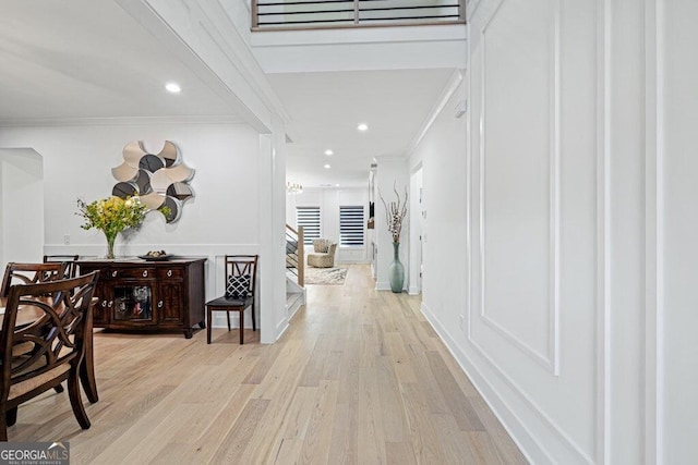 hall with recessed lighting, light wood-type flooring, and crown molding