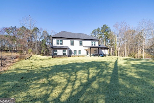 rear view of property with a yard