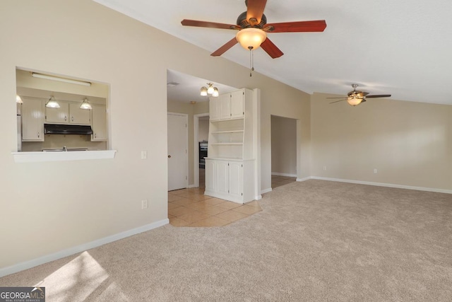 unfurnished living room with light tile patterned floors, light carpet, vaulted ceiling, ceiling fan, and baseboards