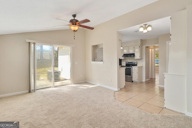 unfurnished living room featuring light carpet, vaulted ceiling, baseboards, and ceiling fan with notable chandelier